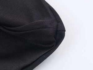 Close-up of black knitted mesh fabric with breathable texture and premium stitching