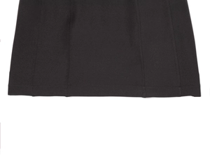 Detail of the stitched hem and vertical seams on a black pleated mini dress fabric