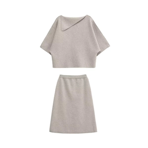 Chic oatmeal knit set featuring asymmetric collar top and high-waist A-line midi skirt