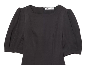 Detail of black mini dress with pleated puff sleeves and invisible back zipper closure