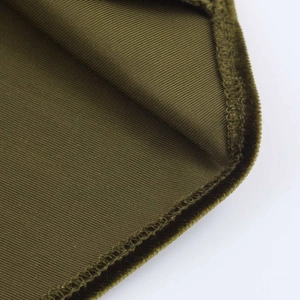 Detail of dark olive green dress showing ribbed knit interior and velvet texture