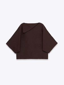 Detail of dark brown knit top featuring a unique asymmetric triangle collar and batwing sleeves