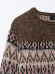 Detail shot of vintage geometric jacquard knit sweater with round neck and plush texture