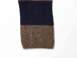 Close-up detail of a vertical rib knit sweater showing navy and brown striped texture
