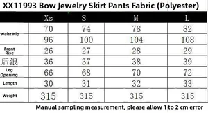 Tabella taglie dettagliata per la gonna-pantalone con fiocco, fibbia di strass e misure
