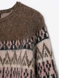 Detailed close-up of vintage geometric jacquard knit texture with soft fuzzy mohair fibers