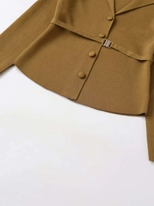 Detail of knit cardigan fabric with matching belt and branded metallic buckle accent