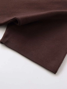 Close-up of premium dark brown knit fabric texture for fashion sweater and skirt set