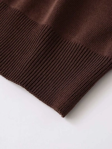 Detail shot of deep brown knit cardigan showing fine ribbed hem and high-elastic texture