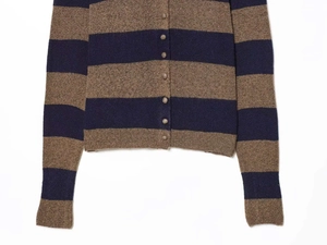 Detail of round buttons and rib-knit cuffs on a brown and navy striped cardigan