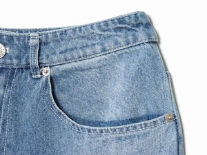Close-up of high-waisted denim jeans showing metal button, pockets, and stitching details