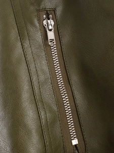 Detailed view of silver metal zipper and textured olive green faux leather jacket fabric