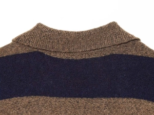 Close-up of the ribbed crew neck and textured stripe knit fabric on this sweater