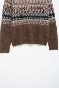 Close-up of Fair Isle geometric jacquard pattern on brown fuzzy mohair knit sweater