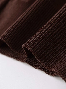 Detail shot of the ribbed knit cuff in dark brown fabric with high quality texture
