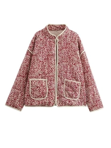 Detail of red floral quilted jacket featuring large front pockets and standing collar