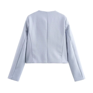Rear view of light blue tweed cropped jacket with textured weave and central seam
