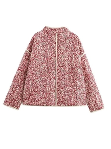 Detail showing red floral quilted jacket with white piping and square stitching texture