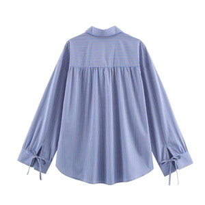 Relaxed blue striped long sleeve shirt with unique cuff ties and curved hem detail
