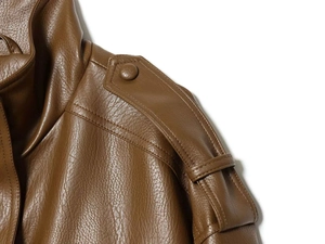 Detail of brown leather jacket showing natural texture and stitched shoulder epaulettes