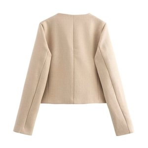 Back view of a cropped cream tweed jacket showing elegant texture and clean stitching
