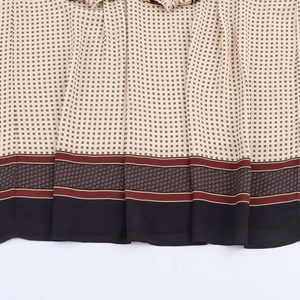 Detail of printed patchwork dress featuring floral patterns and geometric ring motifs