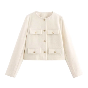 Detailed view of cream tweed jacket with four flap pockets and gold buttons