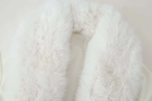 Macro shot of premium soft white faux fur collar texture and long fibers detail
