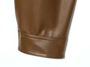 Detailed view of caramel brown faux leather jacket sleeve with premium double stitching