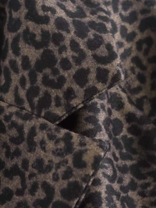 Close-up of leopard print wool blend fabric showing thick texture and pattern details