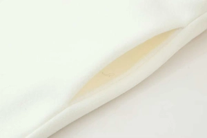 Detail view of the soft white fleece fabric texture and pocket opening of the long coat