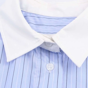 Detailed close-up of light blue striped shirt featuring a white contrast collar and buttons