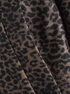 Macro shot of high-quality leopard print fabric texture with soft faux suede feel