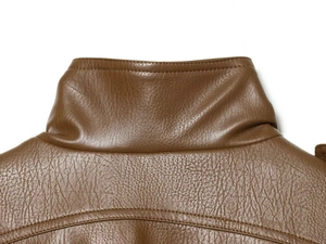 Detailed macro view of the stand-up collar and pebbled texture on a brown faux leather jacket