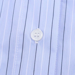 Detailed close-up of blue and white striped fabric with a white button on the shirt front