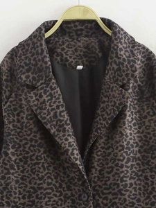 Detail of the leopard print blazer showing the notch lapel and black inner lining