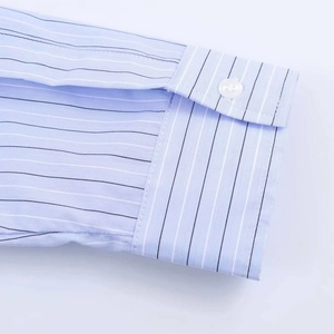Close-up of light blue striped long sleeve shirt cuff with white button detail