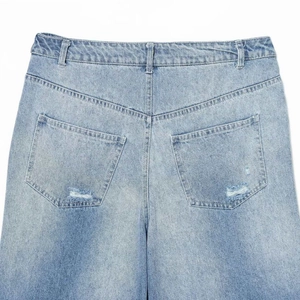 Back view of light blue distressed denim culottes with high waist and ripped pocket detail