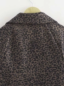 Detailed view of the leopard print collar and shoulder seam on a long autumn coat