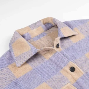 Close-up of purple plaid flannel shirt jacket showing collar and black button details