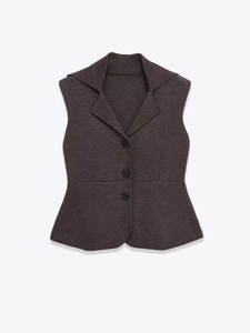 Detail of dark grey sleeveless peplum vest with blazer collar and three front buttons