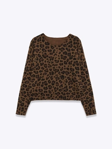 Detail shot of long sleeve knit sweater featuring classic brown leopard print pattern