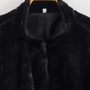 Winter faux fur coat for women with loose stand collar in classic black textured finish