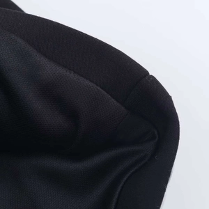 Macro shot of black knit textile fabric texture with detailed stitching for summer romper
