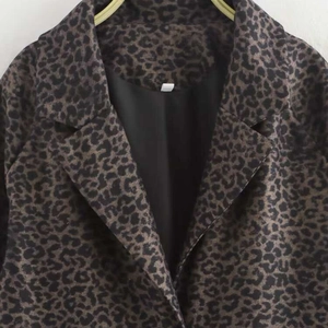Loose vintage leopard print long coat with classic lapel and heavy fabric texture
