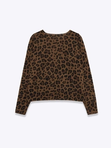 Macro detail of high-quality leopard print knit sweater with ribbed cuffs and round neck