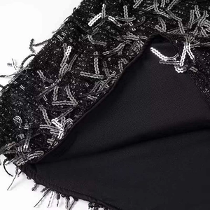 Minimalist black V-neck dress featuring sparkling silver sequins and fringe details