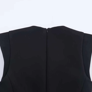 Close-up of black sleeveless jumpsuit with back hidden zipper and tailored fabric details