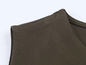 Detailed macro view of military green woven fabric shoulder with durable double-stitch seams