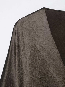 Detail view of the crinkled metallic satin fabric and V-neckline on this elegant dress